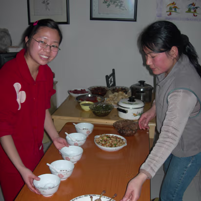 Spring_Festival_06-015 Xiaohua's dishes begin to arrive. Everybody pitches in.