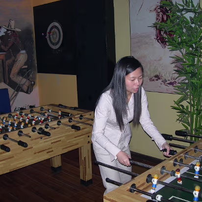 Visitors_Oct_2005-010 Foosball Queen hustling a game.