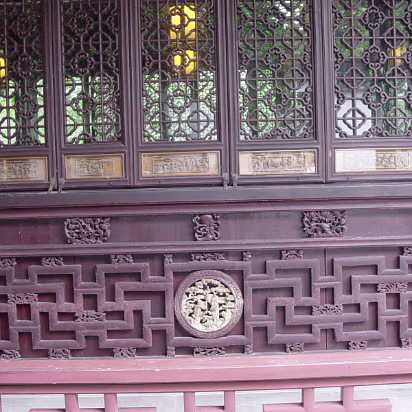 Suzhou-11 'Smell rice hall' wooden screen with carvings showing life at the time.