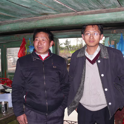 Boat-Buying-21 The junk owner, Mr Ding, and his oldest son. Very nice people to let us in their boat/house.